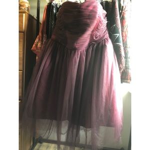 A short, strapless burgundy dress.